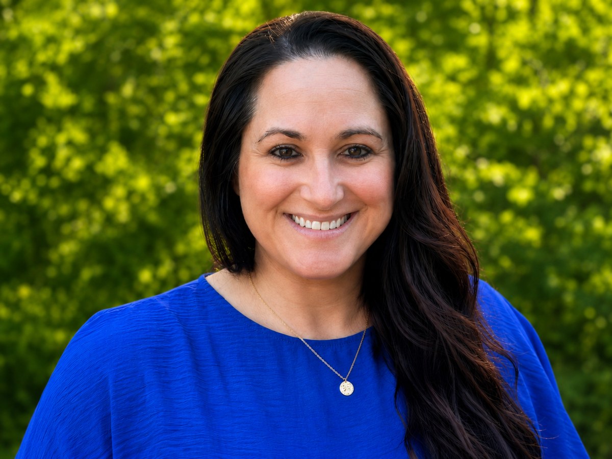 Hannah Chase, founder of New Day Exposure Coaching, smiling outdoors